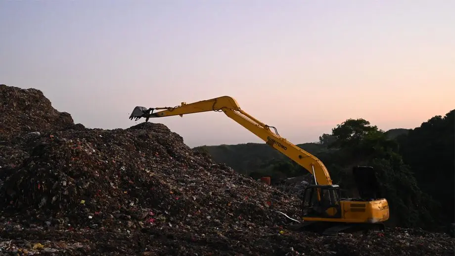 Digger in waste